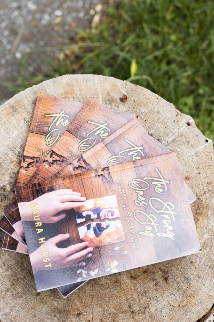 Picture of Laura's books on a stump.